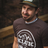 Close up shot of Jed wearing the espresso colored t-shirt showcasing the Kluk Custom Calls logo