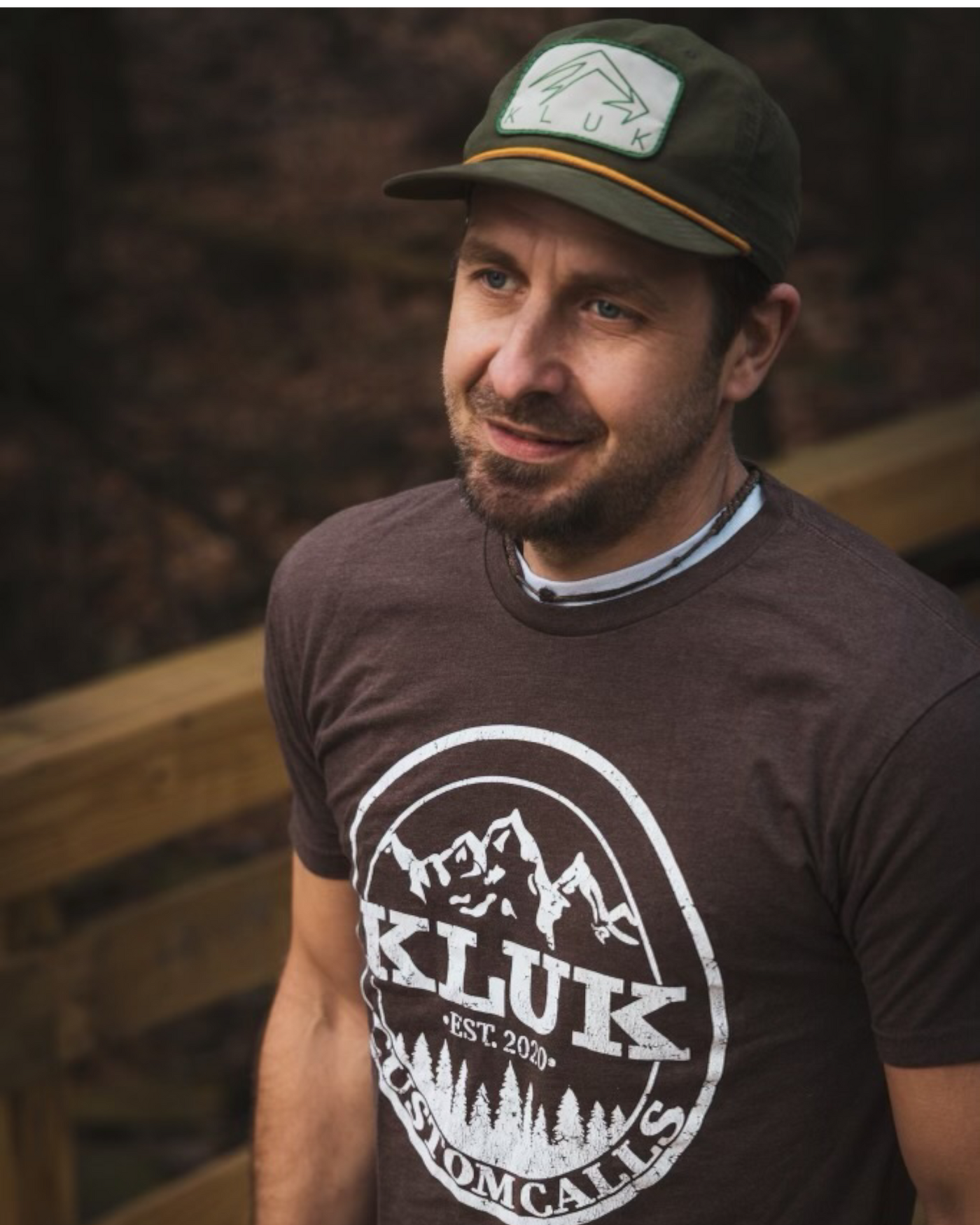 Close up shot of Jed wearing the espresso colored t-shirt showcasing the Kluk Custom Calls logo