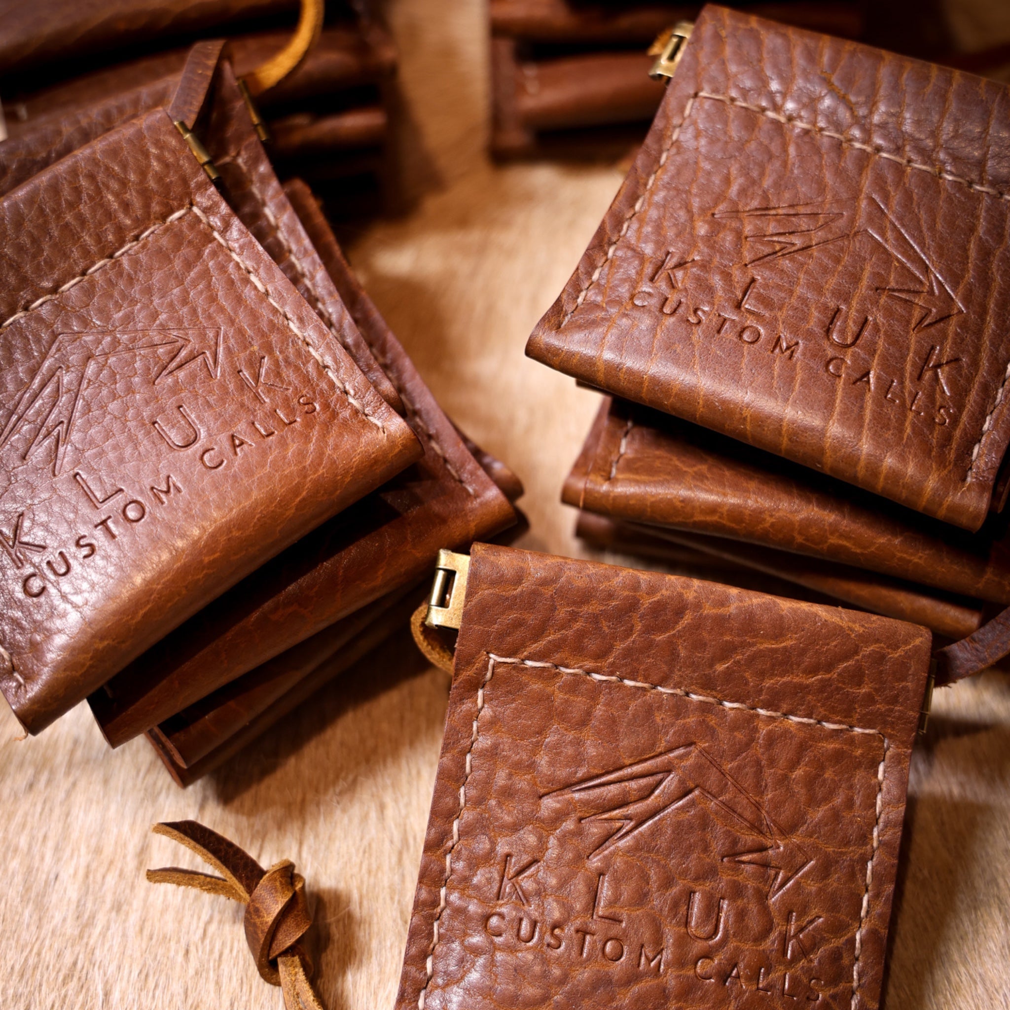 Leather turkey mouth calls stacked displaying logo macro photograph