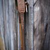 Leather turkey tote product shot hung up against barn door
